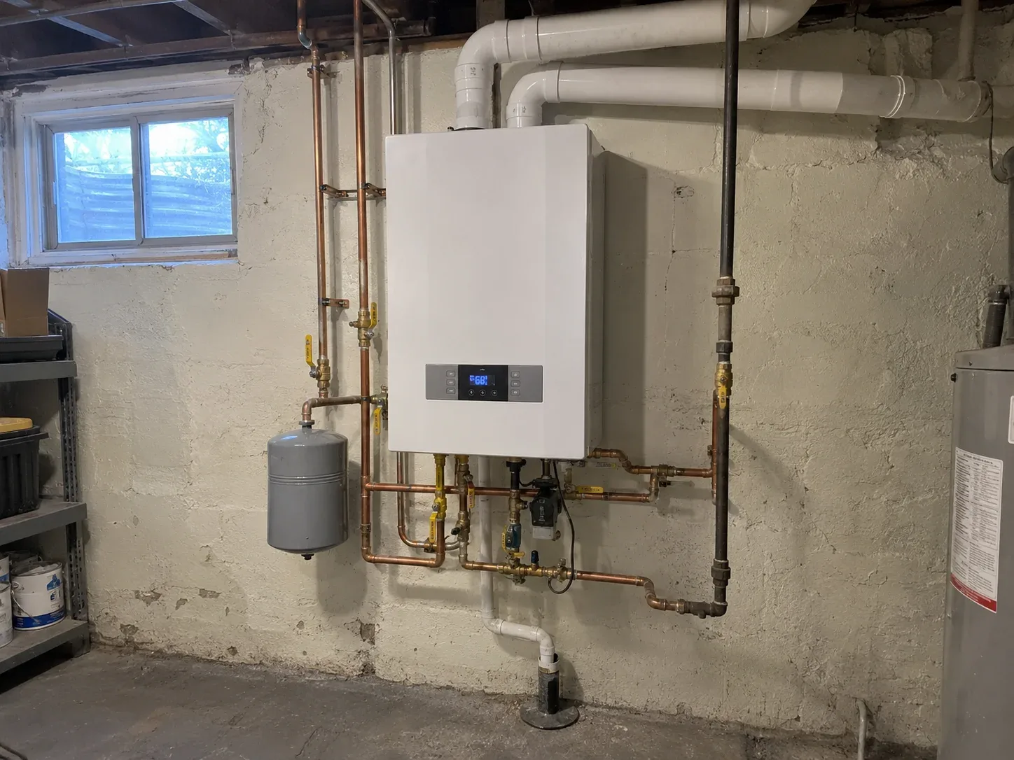 Boiler installation Toronto — technician mounting a new wall-hung boiler in a Toronto home